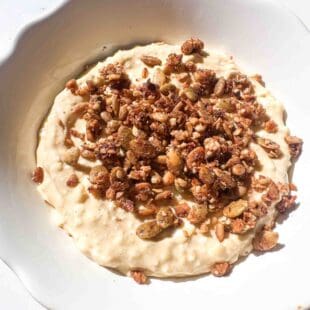 protein cheesecake filling in a bowl topped with granola